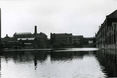 Oblong stretch of water surrounded by warehouses