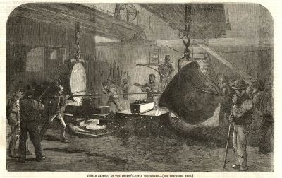 Dark scheme of men around various pieces of equipment in a factory