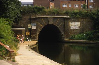 West portal, circa 1970, tunnel mouth in view, people standing near on towing path