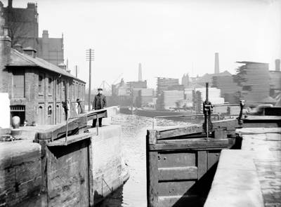 Lock gates with industrial building to the left of the lock