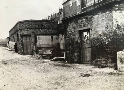 Old rather dilapidated buildings to side of towing path