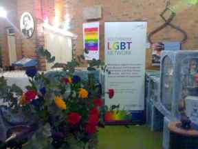 Promotional banners for launch event, flowers foreground, exhibits behind